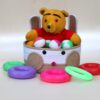 Woven cotton rope bunny basket filled with a plush teddy bear and colorful toy rings