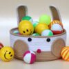 Soft cotton rope bunny basket packed with vibrant yellow smiley balls for playroom organization