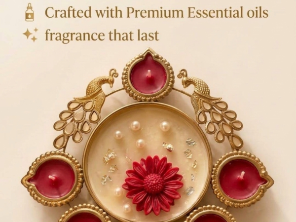 Gold peacock metal diya platter with rich red wax candles and central pearl flower dish